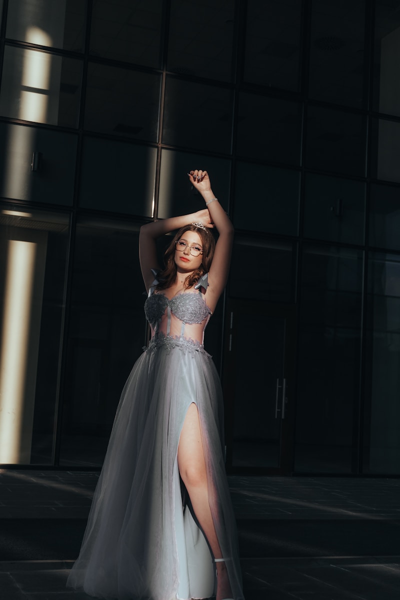 a woman in a gray dress posing for a picture